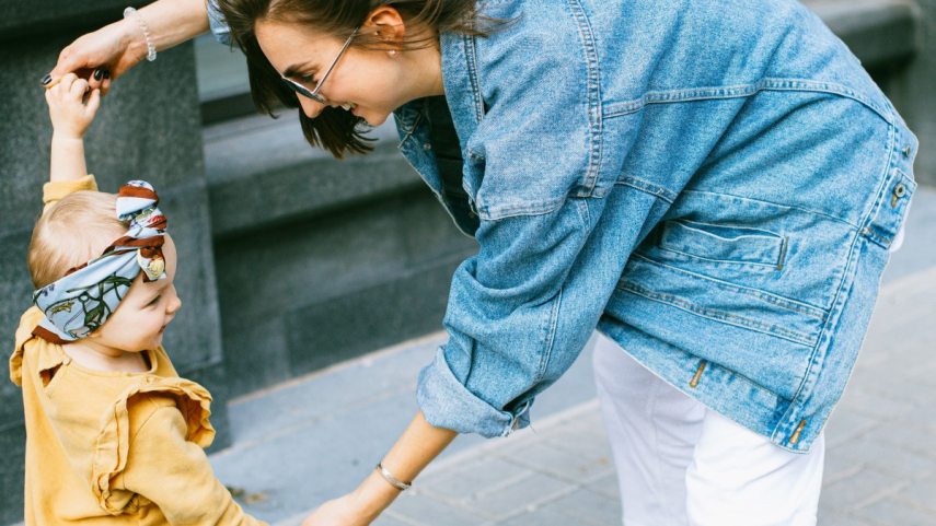 woman-in-blue-denim-jacket-and-white-pants-holding-girl-in-3662772.jpg