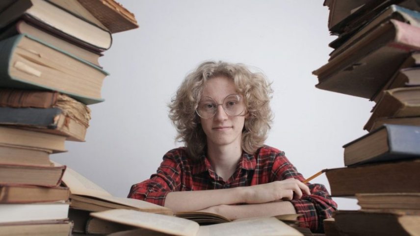 smiling-teenager-with-many-books-3853427-e1590815195760.jpg