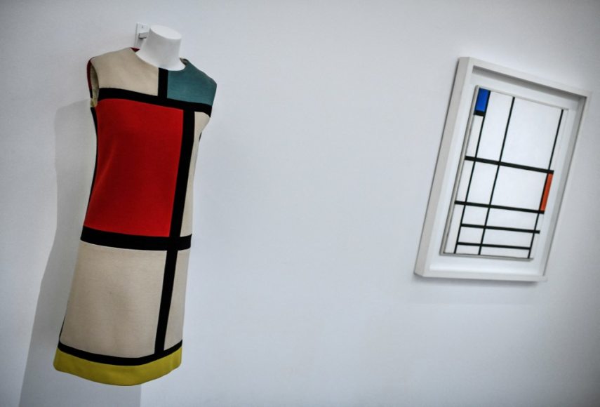 This photograph taken in Paris on January 25, 2022 shows a creation of late French designer Yves Saint-Laurent displayed next a painting by artist Piet Mondrian at the Centre Pompidou (National Modern Art Museum) as part of the exhibitions "Yves Saint-Laurent at the museums". (Photo by STEPHANE DE SAKUTIN / AFP) / RESTRICTED TO EDITORIAL USE - MANDATORY MENTION OF THE ARTIST UPON PUBLICATION - TO ILLUSTRATE THE EVENT AS SPECIFIED IN THE CAPTION - NO ARCHIVES - NO USE AFTER MAY 16, 2022