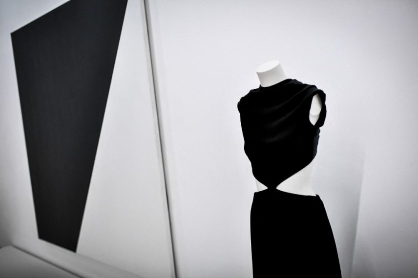 is photograph taken in Paris on January 25, 2022 shows a creation of late French fashion designer Yves Saint-Laurent displayed next a painting entitled "Black White" by US artist Ellsworth Kelly at the Centre Pompidou (National Modern Art Museum), as part of the exhibitions "Yves Saint-Laurent at the Mmuseums". (Photo by STEPHANE DE SAKUTIN / AFP) / RESTRICTED TO EDITORIAL USE - MANDATORY MENTION OF THE ARTIST UPON PUBLICATION - TO ILLUSTRATE THE EVENT AS SPECIFIED IN THE CAPTION