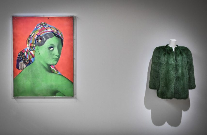 This photograph taken in Paris on January 25, 2022 shows a creation of late French designer Yves Saint-Laurent displayed next a painting entitled 'Made in Japan - La Grande Odalisque'  by artist Martial Raysse at the Centre Pompidou (National Modern Art Museum) as part of the exhibitions "Yves Saint-Laurent at the museums". (Photo by STEPHANE DE SAKUTIN / AFP) / RESTRICTED TO EDITORIAL USE - MANDATORY MENTION OF THE ARTIST UPON PUBLICATION - TO ILLUSTRATE THE EVENT AS SPECIFIED IN THE CAPTION - - NO ARCHIVES - NO USE AFTER MAY 16, 2022