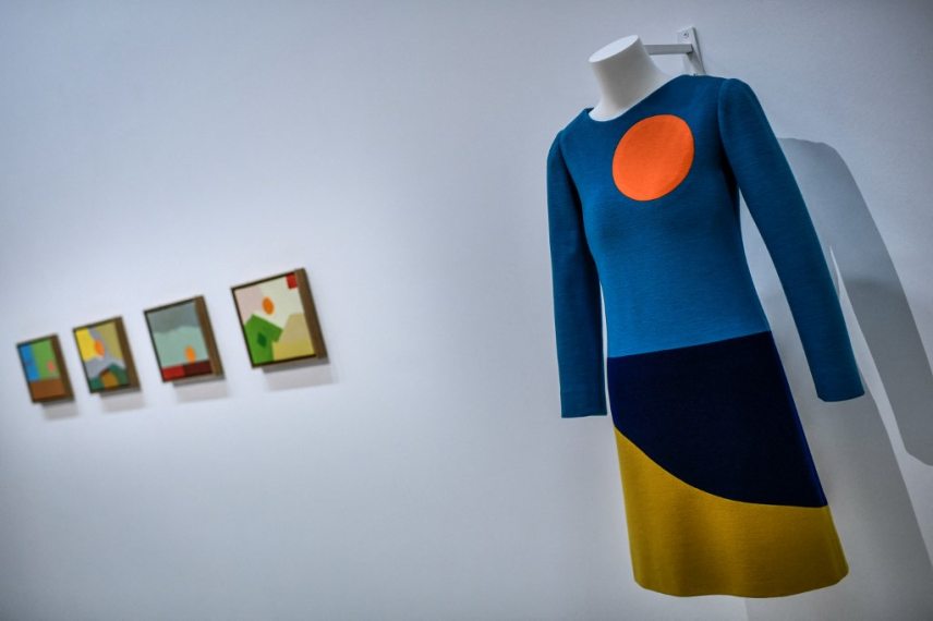 This photograph taken in Paris on January 25, 2022 shows a creation of late French designer Yves Saint-Laurent displayed next paintings by Lebanese-American artist Etel Adnan at the Centre Pompidou (National Modern Art Museum) as part of the exhibitions "Yves Saint-Laurent at the museums". (Photo by STEPHANE DE SAKUTIN / AFP) / RESTRICTED TO EDITORIAL USE - MANDATORY MENTION OF THE ARTIST UPON PUBLICATION - TO ILLUSTRATE THE EVENT AS SPECIFIED IN THE CAPTION - NO ARCHIVES - NO USE AFTER MAY 16, 2022