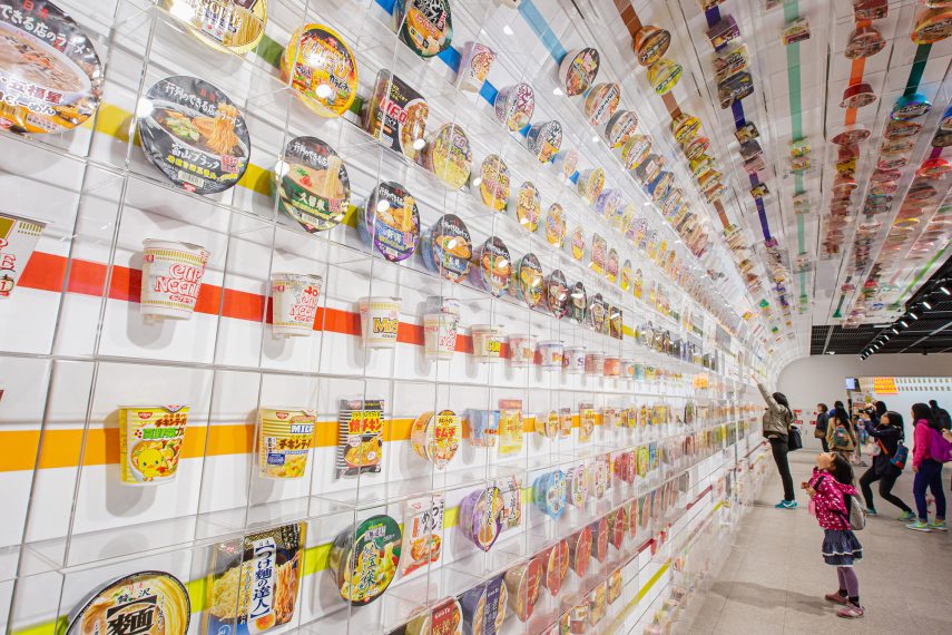 April 4, 2016 Osaka, Japan - Little girl look up many cup noodles decoration on wall exhibition tell story aboout instant noodles at The Cup Noodles Museum Osaka.