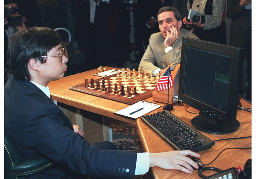 World Chess Champion Garry Kasparov (R) pauses before making his first move in a game against the IBM Deep Blue computer on May 3, 1997 in New York. Feng-Hsiung Hsu (L) from IBM, played the computers' moves, which appeared on the monitor at right. Kasparov will play six games against the computer 03-11 May.
STAN HONDA / AFP