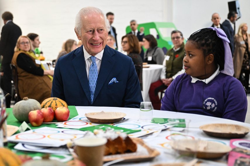 Britain's King Charles III (L) speaks with pupils of the primary school Rye Oak benefiting from the Coronation Food Project, as he visits to the Coronation Food Project hub, located at the Deptford Trading Estate, in southeastern London, on November 14, 2024, during the centre inauguration. To celebrate his 76th birthday and the first anniversary of the Coronation Food Project, the King opened the initiative’s first two Coronation Food Hubs – one in person and one virtually. The hubs are major distribution centres, designed to save and circulate surplus food and to support communities in need. (Photo by JUSTIN TALLIS / POOL / AFP)