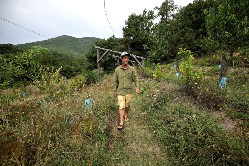 Antoine Talin, permaculture trainer, landscape architect specialising in regenerative landscape design and founder of "Atelier Les Alveoles", a design office and agroforestry nursery, walks in the gardens of "Les Alveoles", in Cobonne, south-eastern France, on August 14, 2024. Replant hedges, cultivate terraces, plug up drains... In the Drome region, faced with increasingly frequent droughts, farmers are resorting to common sense measures to "slow down the water cycle".
Valentine CHAPUIS / AFP