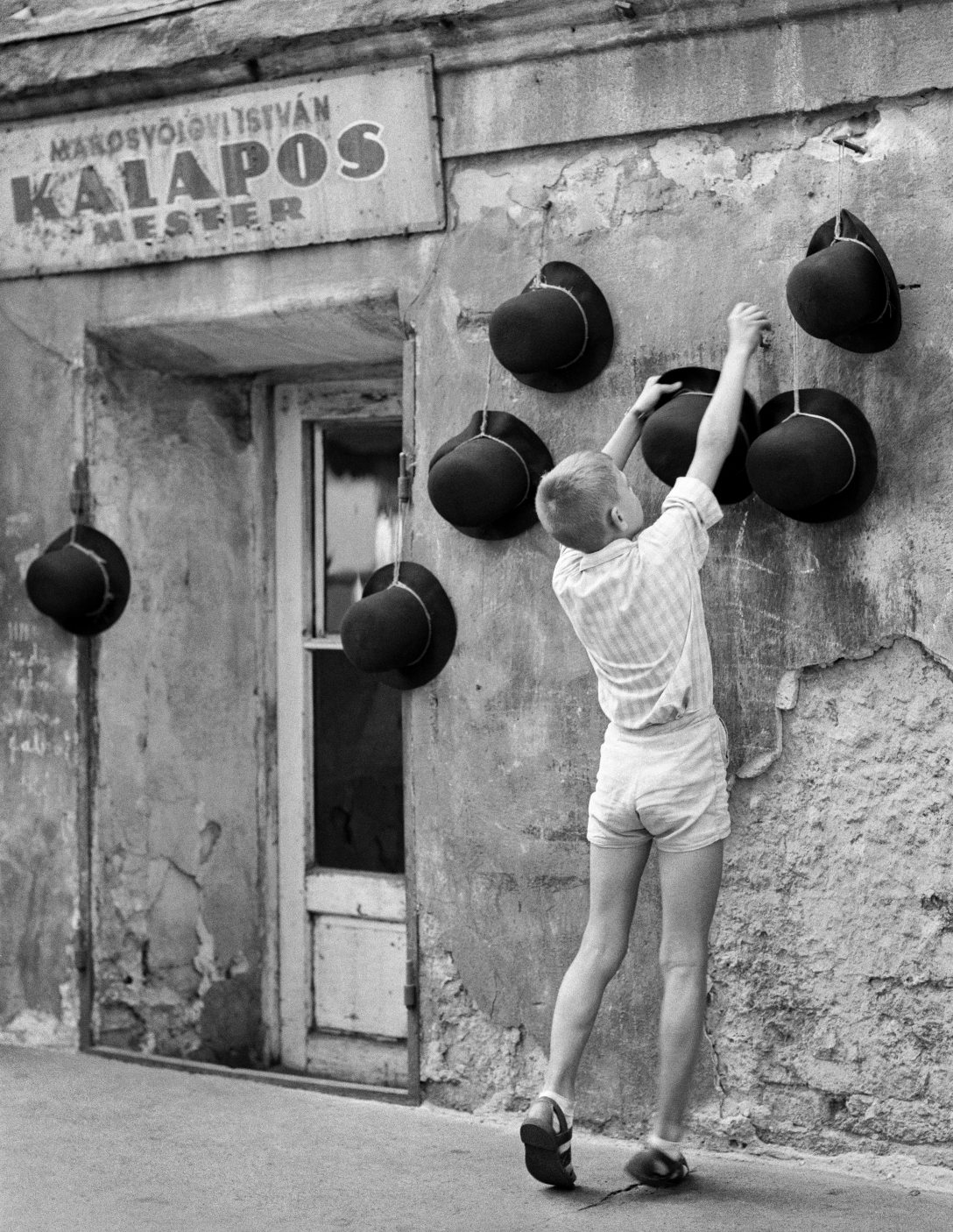 Kalaposinas Marosvölgyi István kalaposmester műhelye előtt, a XIII. kerületi Visegrádi utca 20–24-ben 1960-ban. Fotó: Fortepan / Hegyi Zsolt / Balla Demeter